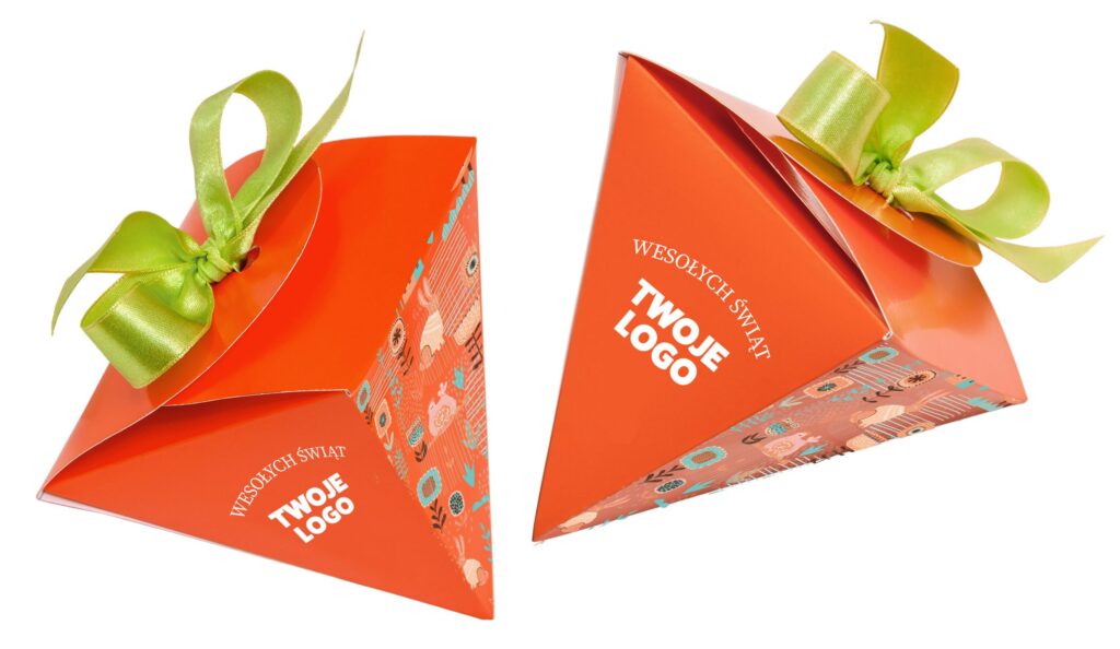 pudełko marchewki z czekoladkami w różnych smakach i satynową wstążką z logo firmy